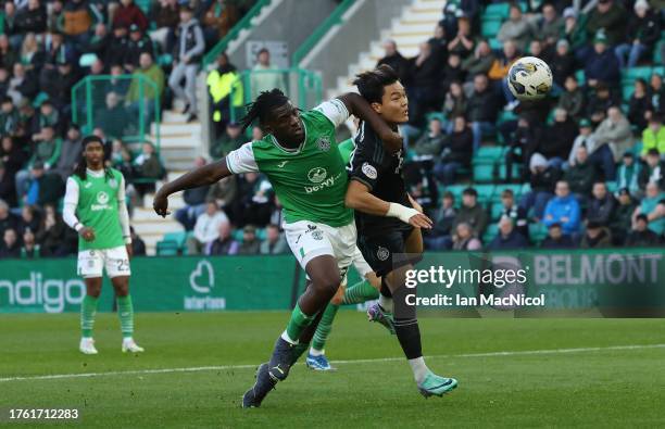 Rocky Bushiri of Hibernian vies with Oh Hyeongyu of Celtic during the Cinch Scottish Premiership match between Hibernian FC and Celtic FC at Easter...