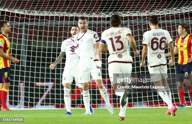 Alessandro Buongiorno of Torino celebrates with his teammates after scoring his team's first goal during the Serie A TIM match between US Lecce and...