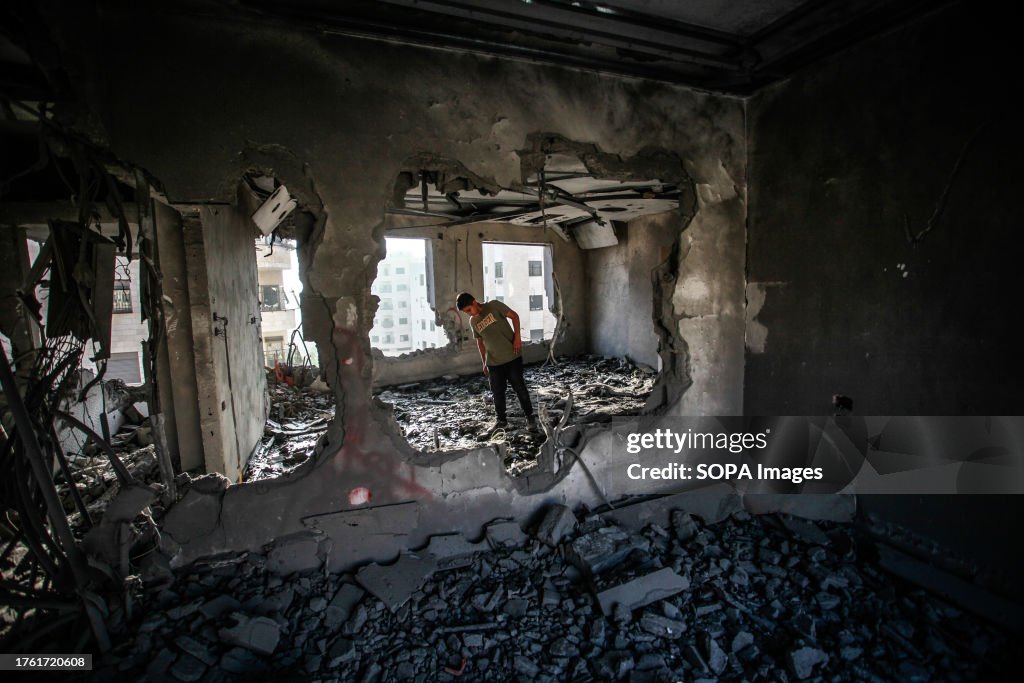 A Palestinian inspects the apartment of Khaled Kharousha...