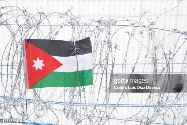 the flag of jordan on a barbed wire fence - jordanian flag stock pictures, royalty-free photos & images