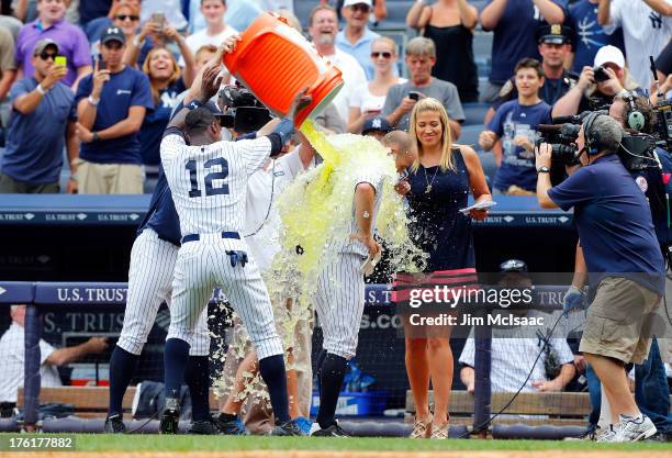 Alfonso Soriano of the New York Yankees dumps Gatorade on teammate Brett Gardner in celebration of Gardner's game winning home run in the ninth...