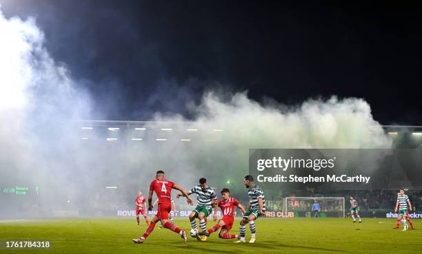 Dublin , Ireland - 3 November 2023; Niall Morahan of Sligo Rovers in action against Neil Farrugia and Richie Towell of Shamrock Rovers as smoke rises...