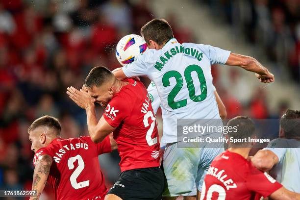 Martin Valjent of RCD Mallorca competes for the ball with Nemanja Maksimovic of Getafe CF during the LaLiga EA Sports match between RCD Mallorca and...