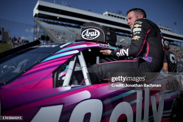 Alex Bowman, driver of the Ally Chevrolet, enters his car during qualifying for the NASCAR Cup Series Xfinity 500 at Martinsville Speedway on October...