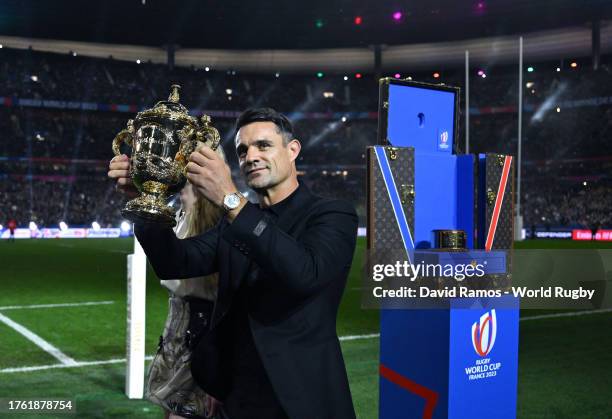 Dan Carter lifts the trophy as The Webb Ellis Cup arrives in the Louis Vuitton trunk prior to kick-off ahead of the Rugby World Cup Final match...