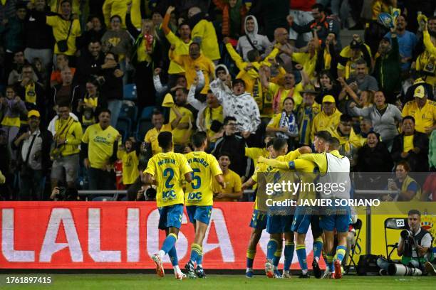 Las Palmas' players celebrate the opening goal scored by Las Palmas' Spanish midfielder Kirian Rodríguez during the Spanish league football match...