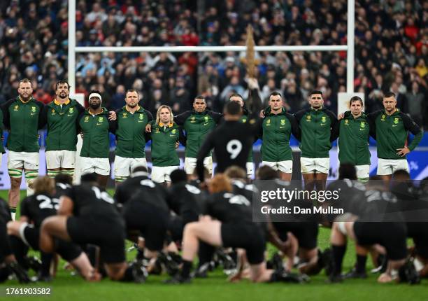 Players of South Africa watch as players of New Zealand perform the Haka prior to kick-off ahead of the Rugby World Cup Final match between New...