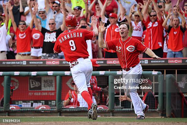 Jay Bruce celebrates with Jack Hannahan of the Cincinnati Reds after Hannahan scored the winning run against the San Diego Padres in the 13th inning...