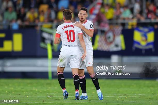 Lucas Ocampos of Sevilla FC celebrates with teammate Ivan Rakitic after scoring the team's first goal during the LaLiga EA Sports match between Cadiz...