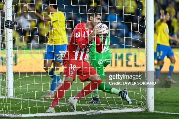 Atletico Madrid's Spanish forward Alvaro Morata takes the ball after scoring a goal during the Spanish league football match between UD Las Palmas...