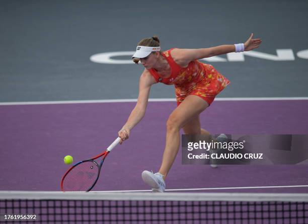 Kazakhstan's Elena Rybakina returns the ball against Belarus' Aryna Sabalenka during their women's singles match of the WTA Finals tennis...