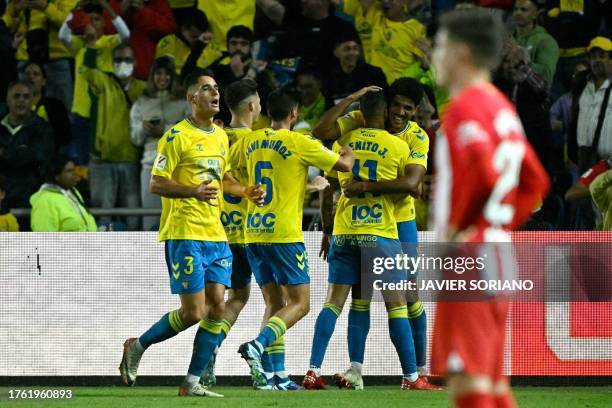 Las Palmas' Spanish forward Benito Ramirez celebrates with teammates scoring his team's second goal during the Spanish league football match between...