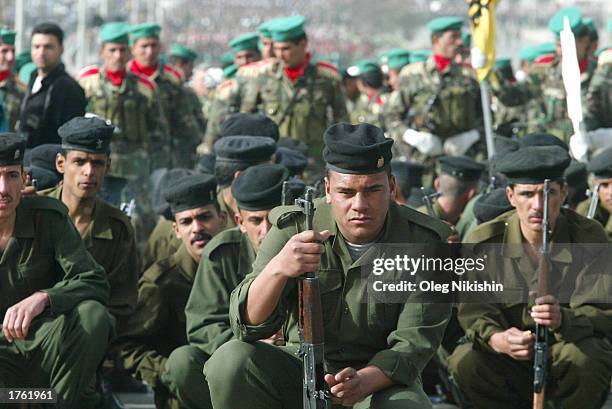 Iraqi soldiers sit before a march in defiance of U.S. Threats to invade Iraq February 4, 2003 in the city of Mosul, 450 kilometers north of Baghdad....