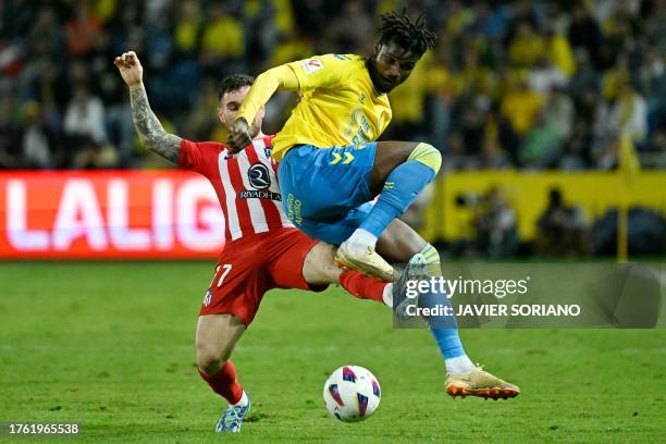 Atletico Madrid's Spanish defender Javi Galan vies with Las Palmas' Guinean forward Sory Kaba during the Spanish league football match between UD Las...