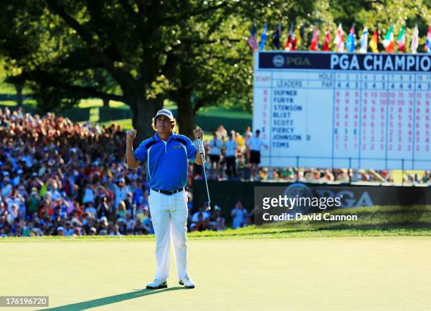 Jason Dufner of the United States celebrates on the 18th green after his two-stroke victory at the 95th PGA Championship at Oak Hill Country Club on...