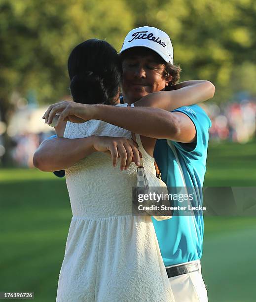 Jason Dufner of the United States hugs his wife Amanda after his two-stroke victory at the 95th PGA Championship at Oak Hill Country Club on August...