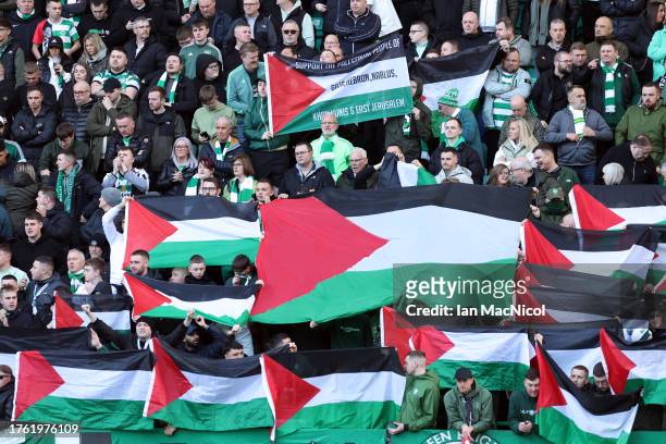 Celtic fans display Palestine flags during the Cinch Scottish Premiership match between Hibernian FC and Celtic FC at Easter Road on October 28, 2023...