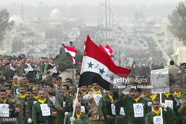 Iraqi men participate during a march in defiance of U.S. Threats to invade Iraq February 4, 2003 in the city of Mosul, 450 kilometers north of...