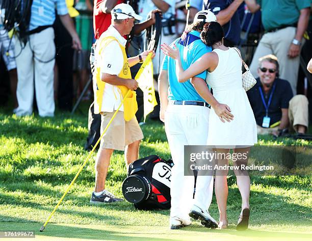 Jason Dufner of the United States hugs his wife Amanda on the 18th green after his two-stroke victory at the 95th PGA Championship at Oak Hill...