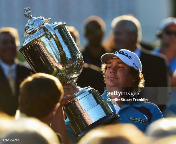 Jason Dufner of the United States looks at the Wanamaker Trophy after his two-stroke victory at the 95th PGA Championship at Oak Hill Country Club on...