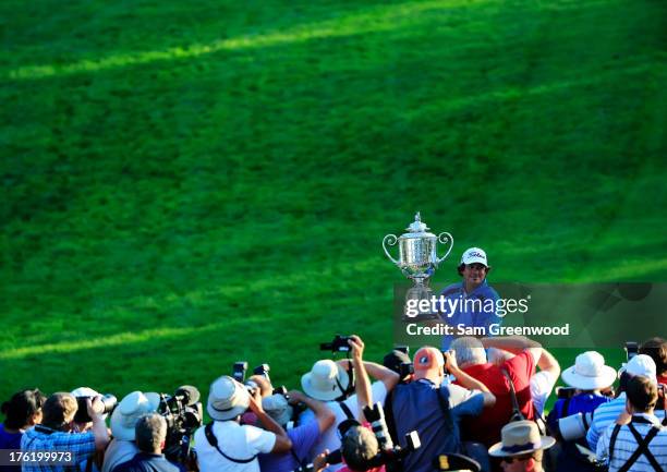 Jason Dufner of the United States poses for photographers with the Wanamaker Trophy after his two-stroke victory at the 95th PGA Championship at Oak...