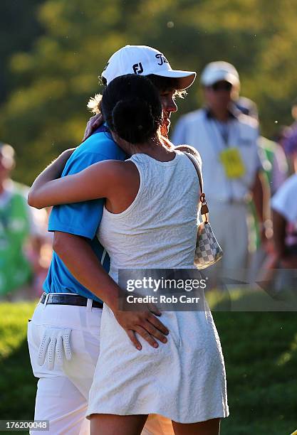 Jason Dufner of the United States hugs his wife Amanda on the 18th green after his two-stroke victory at the 95th PGA Championship at Oak Hill...