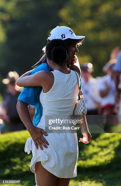 Jason Dufner of the United States hugs his wife Amanda on the 18th green after his two-stroke victory at the 95th PGA Championship at Oak Hill...