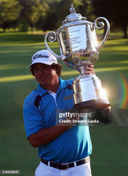 Jason Dufner of the United States celebrates with the Wanamaker Trophy after his two-stroke victory at the 95th PGA Championship at Oak Hill Country...
