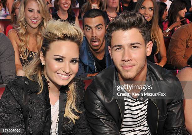 Musicians Demi Lovato, Joe Jonas, and Nick Jonas attend the 2013 Teen Choice Awards at Gibson Amphitheatre on August 11, 2013 in Universal City,...