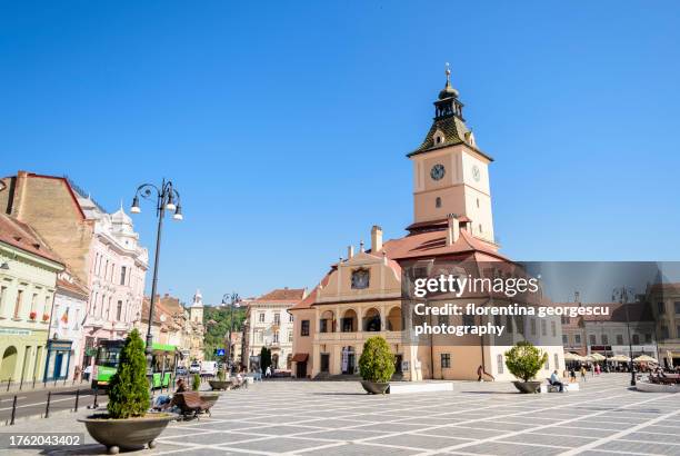 the council house topped by the trumpeter's watchtower, now housing brasov historical museum, in the center of the council square in the heart of the medieval saxon old town, transylvania, romania - brasov council square stock pictures, royalty-free photos & images