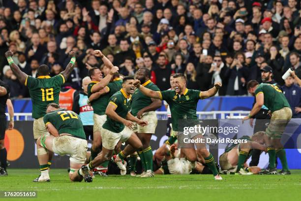 Handre Pollard of South Africa celebrates with teammates following the team’s victory at the final whistle during the Rugby World Cup Final match...