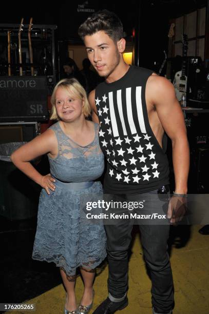 Actress Lauren Potter and musician Nick Jonas attend the 2013 Teen Choice Awards at Gibson Amphitheatre on August 11, 2013 in Universal City,...