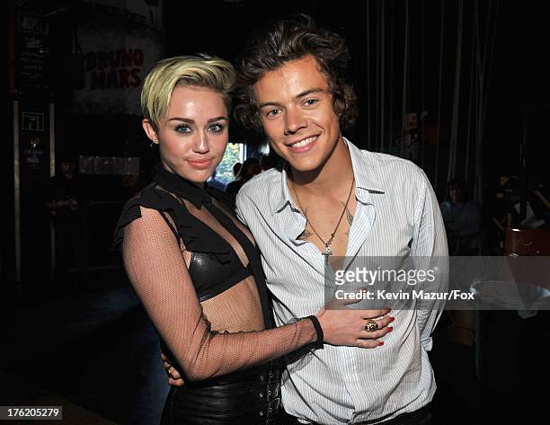 Actress/musician Miley Cyrus and musician Harry Styles of One Direction attend the 2013 Teen Choice Awards at Gibson Amphitheatre on August 11, 2013...