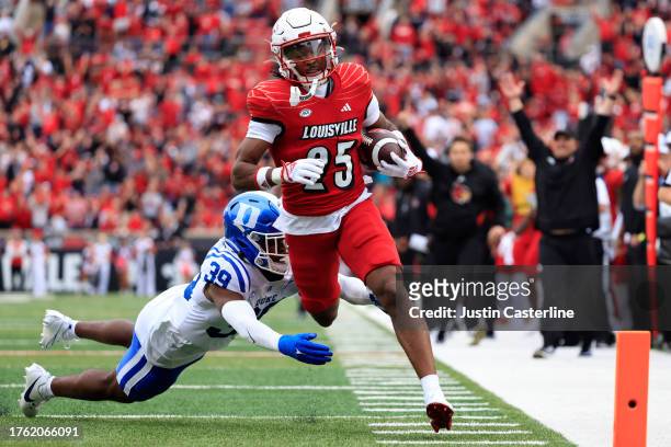 Jawhar Jordan of the Louisville Cardinals runs the ball for a touchdown while defended by Jeremiah Lewis of the Duke Blue Devils during the first...