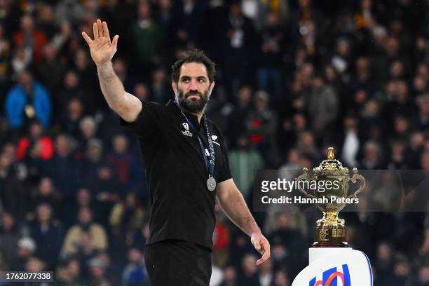 Samuel Whitelock of New Zealand acknowledges the fans as he walks past The Webb Ellis Cup after defeat during the Rugby World Cup Final match between...
