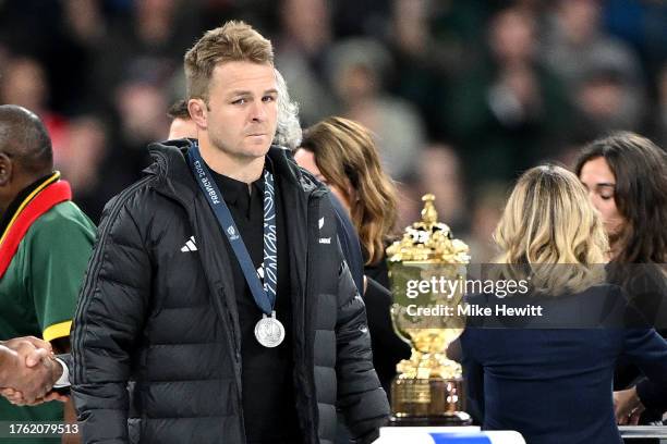 Sam Cane of New Zealand looks dejected as he walks past The Webb Ellis Cup with his runners up medal after defeat during the Rugby World Cup Final...