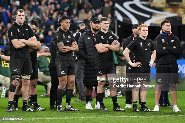 Players of New Zealand look dejected as they wait to collect their runners up medals after defeat during the Rugby World Cup Final match between New...