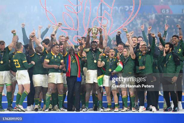 Siya Kolisi of South Africa lifts The Webb Ellis Cup with President Ramaphosa, President of South Africa following the Rugby World Cup Final match...