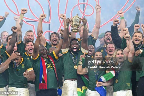 Siya Kolisi of South Africa lifts The Webb Ellis Cup with President Ramaphosa, President of South Africa following the Rugby World Cup Final match...