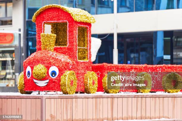 front view of a decorative three with a smiley face outside a shopping mall without people - smiley face stock pictures, royalty-free photos & images