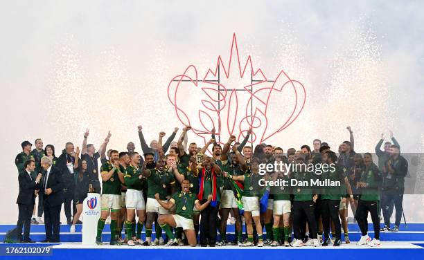 Siya Kolisi of South Africa lifts The Webb Ellis Cup with Cyril Ramaphosa, President of South Africa, following the Rugby World Cup Final match...