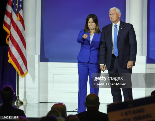 Karen Pence gestures as she and former U.S. Vice President Mike Pence leave the stage after he suspended his campaign for president during the...