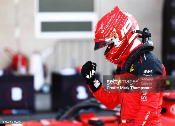 Pole position qualifier Charles Leclerc of Monaco and Ferrari celebrates in parc ferme during qualifying ahead of the F1 Grand Prix of Mexico at...