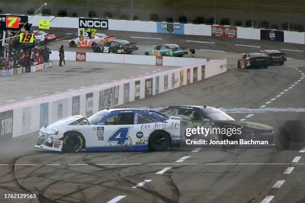 Yeley, driver of the Old House Life Chevrolet, and Ryan Ellis, driver of the KeenParts.com Chevrolet, spin after an on-track incident during the...