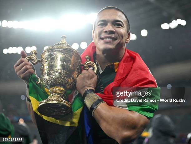 Cheslin Kolbe of South Africa celebrates with The Webb Ellis Cup after defeating New Zealand during the Rugby World Cup Final match between New...