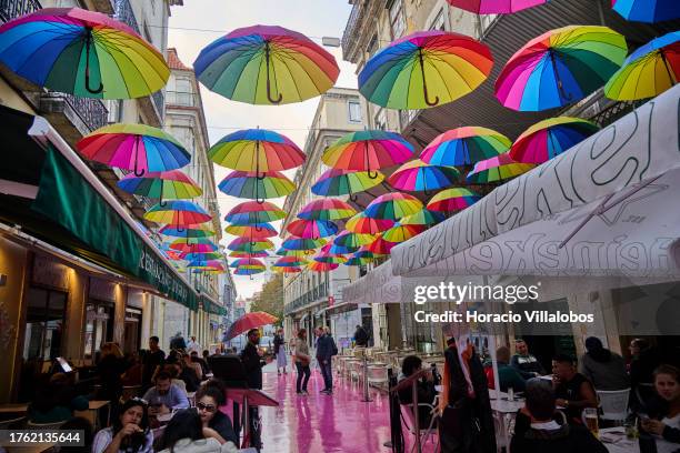 Rainbow umbrellas hang over Pink Street on a rainy afternoon, where is located Madam's Lodge at Pensao Amor hotel on October 28 in Lisbon, Portugal....