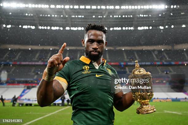 Siya Kolisi of South Africa poses for a photo with the The Webb Ellis Cup following the Rugby World Cup Final match between New Zealand and South...