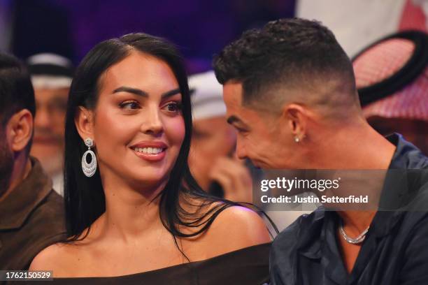 Cristiano Ronaldo and his wife Georgina Rodríguez speak ringside prior to the Heavyweight fight between Tyson Fury and Francis Ngannou at Boulevard...