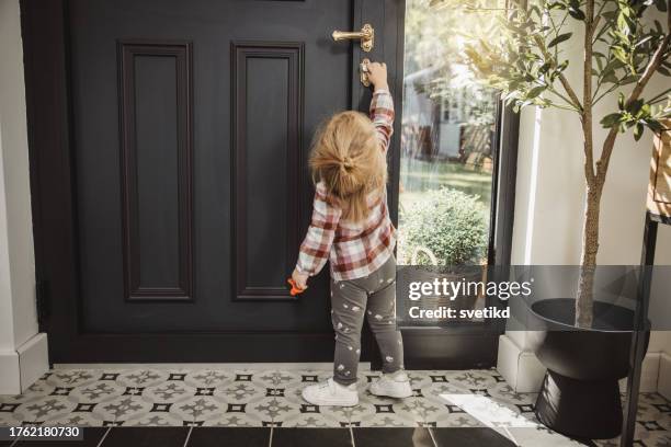 baby trying to open the door - doorknob stock pictures, royalty-free photos & images