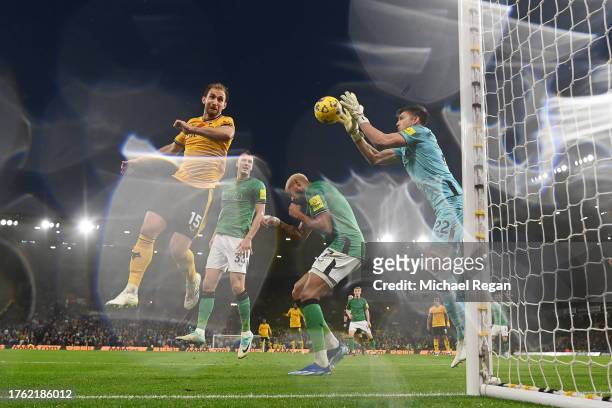 Craig Dawson of Wolverhampton Wanderers challengers for the ball with Nick Pope of Newcastle during the Premier League match between Wolverhampton...
